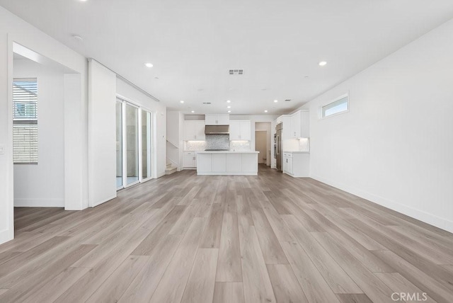 120 Zawn, Irvine, CA 92618 - unfurnished living room with plenty of natural light, light wood finished floors, and baseboards