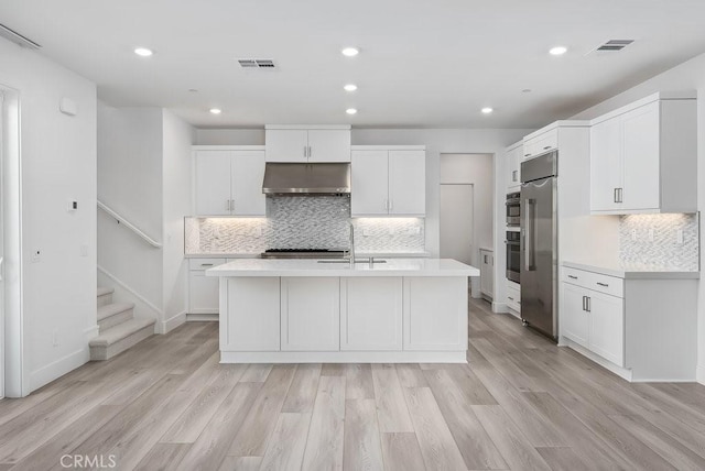 120 Zawn, Irvine, CA 92618 - kitchen featuring tasteful backsplash, built in refrigerator, light countertops, under cabinet range hood, and a sink