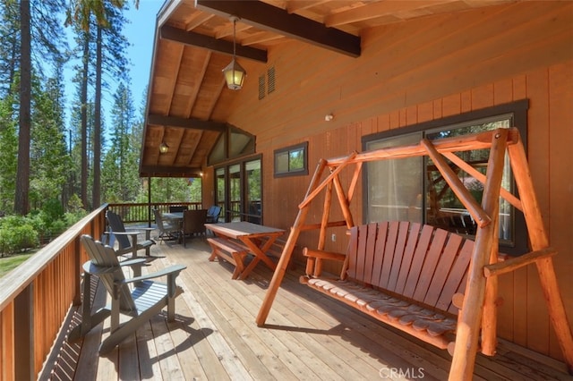 wooden deck with outdoor dining space