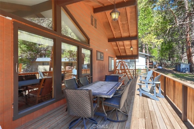 wooden terrace featuring outdoor dining area