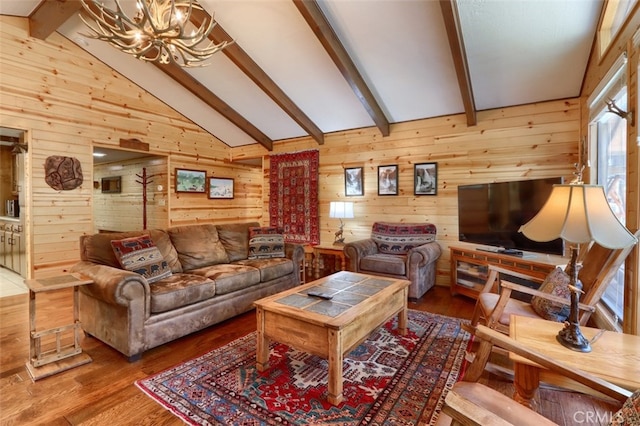 living area with a notable chandelier, wooden walls, wood finished floors, and lofted ceiling with beams
