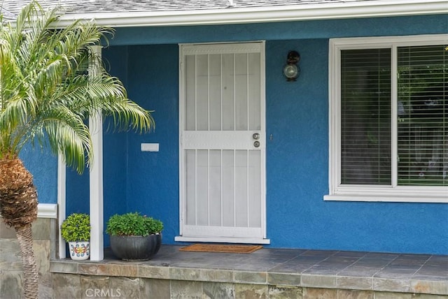 3556 Rutgers Ave, Long Beach, CA 90808 - view of exterior entry with stucco siding and roof with shingles