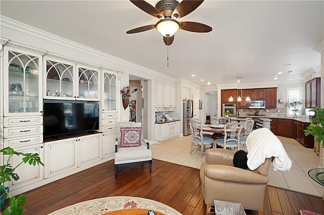 37557 Windsor Ct, Murrieta, CA 92562 - living room with light wood-type flooring, recessed lighting, ornamental molding, and a ceiling fan