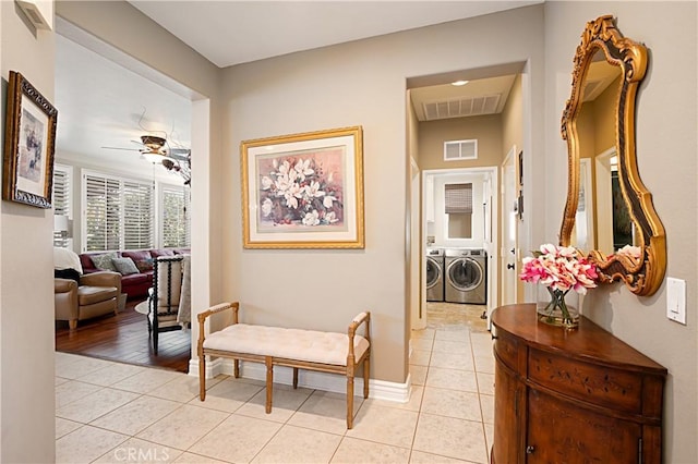 37557 Windsor Ct, Murrieta, CA 92562 - hall featuring light tile patterned floors, washer and clothes dryer, baseboards, and visible vents