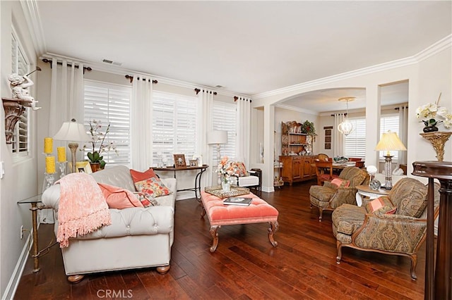 37557 Windsor Ct, Murrieta, CA 92562 - living room featuring visible vents, baseboards, ornamental molding, arched walkways, and wood-type flooring