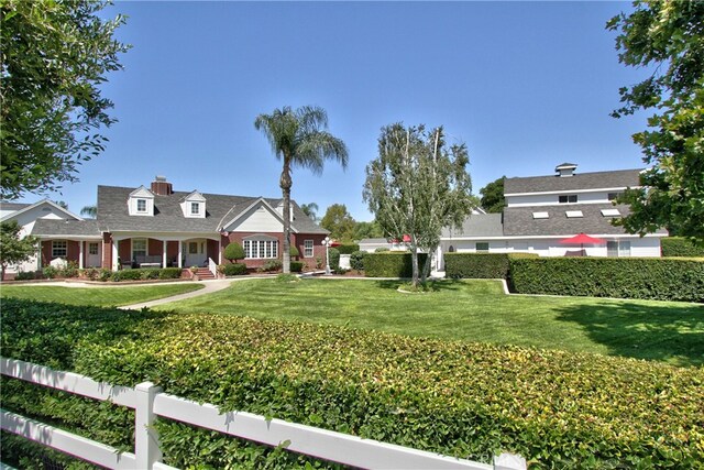 41548 Hutchison Ct, Murrieta, CA 92562 - view of front of home featuring a front lawn, brick siding, and a chimney