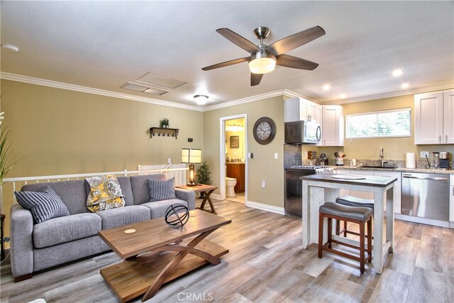 41548 Hutchison Ct, Murrieta, CA 92562 - living area with crown molding, a ceiling fan, light wood-style flooring, and baseboards