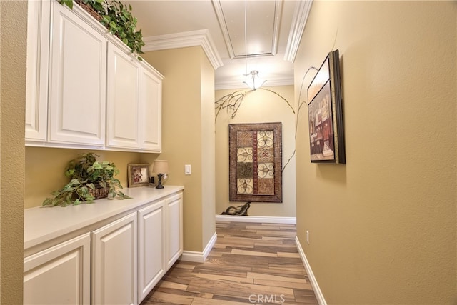 41548 Hutchison Ct, Murrieta, CA 92562 - hallway with light wood finished floors, crown molding, attic access, and baseboards