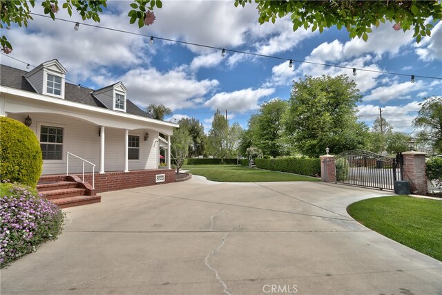 41548 Hutchison Ct, Murrieta, CA 92562 - view of home's exterior featuring a gate, a lawn, and covered porch