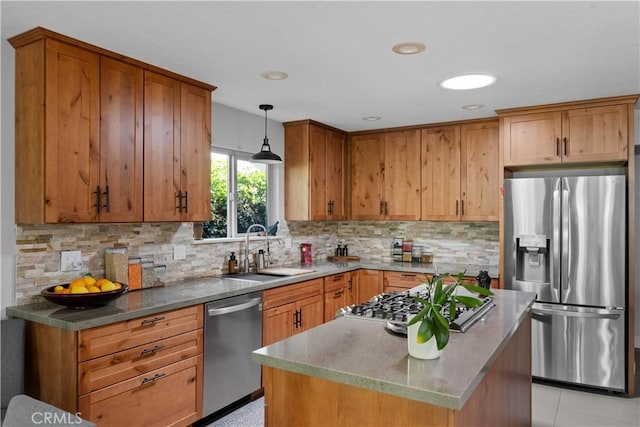 kitchen with a center island, tasteful backsplash, a sink, hanging light fixtures, and stainless steel appliances