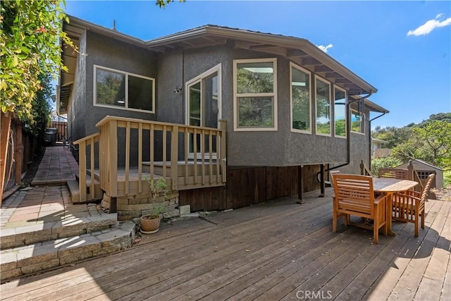 wooden deck with outdoor dining area and fence