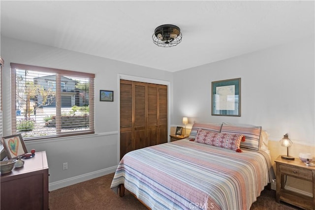 bedroom with baseboards, carpet, and a closet