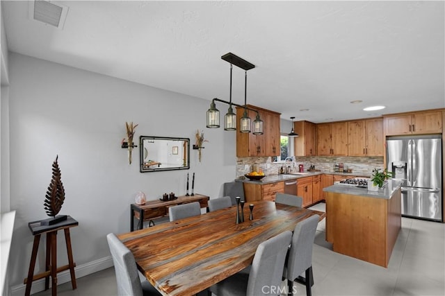 dining room featuring baseboards and visible vents