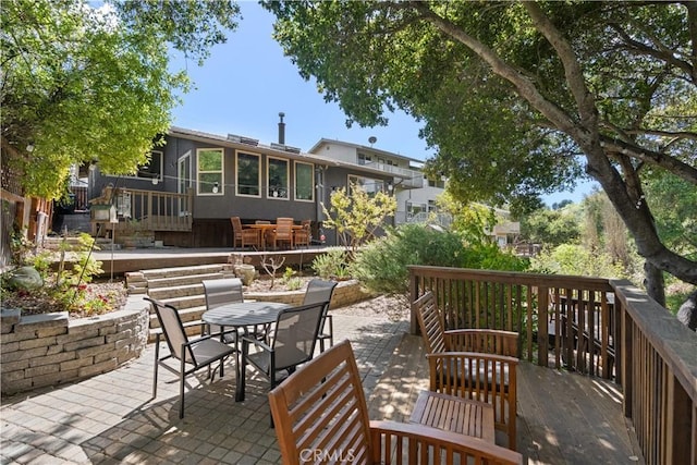 view of patio with a wooden deck and outdoor dining area