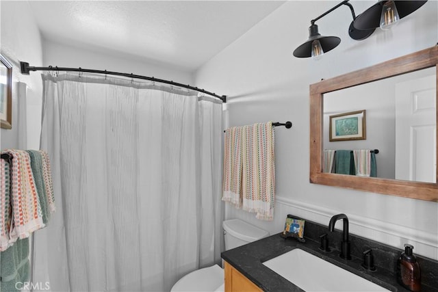 bathroom with vanity, a shower with shower curtain, and toilet