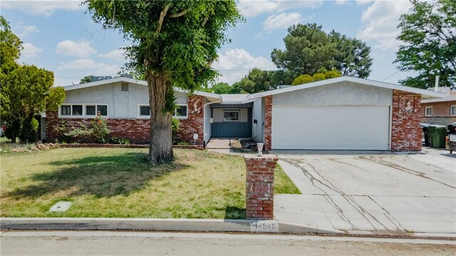 44546 E 3rd St E, Lancaster, CA 93535 - ranch-style house with a garage, concrete driveway, a front yard, and brick siding