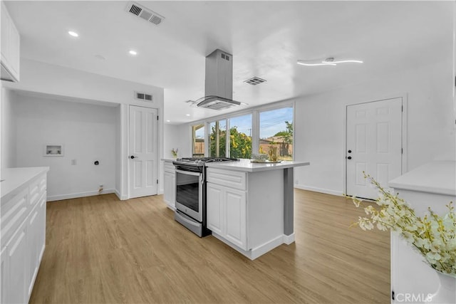44546 E 3rd St E, Lancaster, CA 93535 - kitchen featuring stainless steel stove, light wood-style flooring, light countertops, white cabinets, and recessed lighting