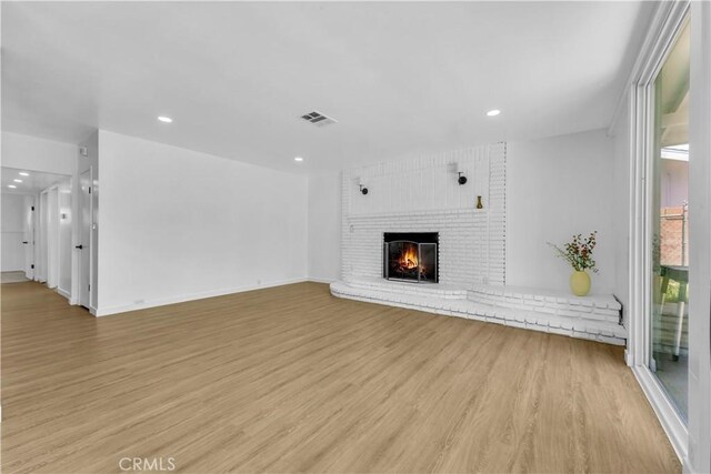 44546 E 3rd St E, Lancaster, CA 93535 - unfurnished living room featuring light wood-style flooring, a fireplace, recessed lighting, and baseboards