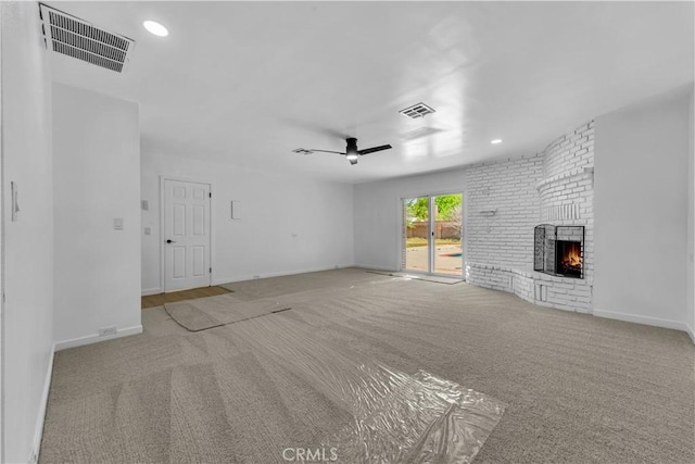 44546 E 3rd St E, Lancaster, CA 93535 - unfurnished living room with carpet, a brick fireplace, a ceiling fan, baseboards, and recessed lighting
