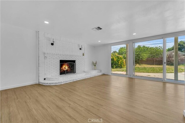 44546 E 3rd St E, Lancaster, CA 93535 - unfurnished living room with wood finished floors, a fireplace, baseboards, and recessed lighting