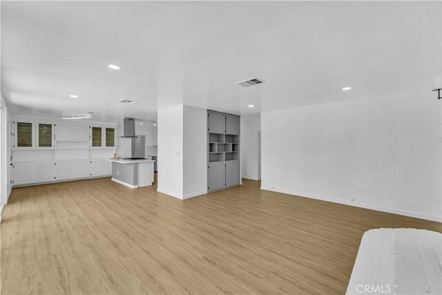 44546 E 3rd St E, Lancaster, CA 93535 - unfurnished living room with light wood finished floors, recessed lighting, and baseboards