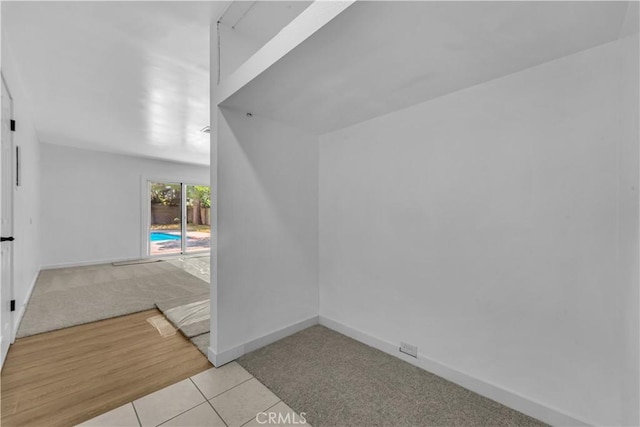 44546 E 3rd St E, Lancaster, CA 93535 - unfurnished room featuring baseboards, light carpet, and light tile patterned floors