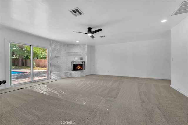 44546 E 3rd St E, Lancaster, CA 93535 - unfurnished living room with carpet floors, a brick fireplace, a ceiling fan, baseboards, and recessed lighting
