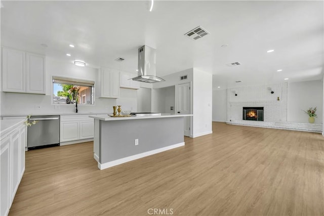 44546 E 3rd St E, Lancaster, CA 93535 - kitchen featuring dishwasher, island exhaust hood, white cabinets, light countertops, and recessed lighting