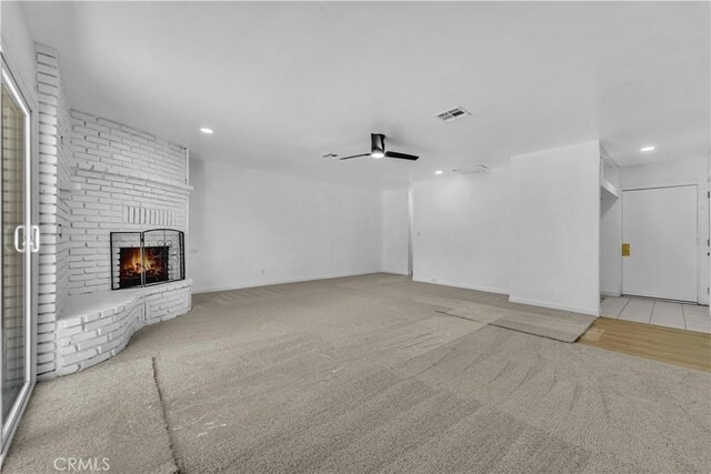 44546 E 3rd St E, Lancaster, CA 93535 - unfurnished living room with carpet, a brick fireplace, recessed lighting, a ceiling fan, and baseboards