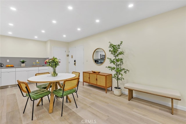 dining space featuring light wood-style flooring, baseboards, and recessed lighting