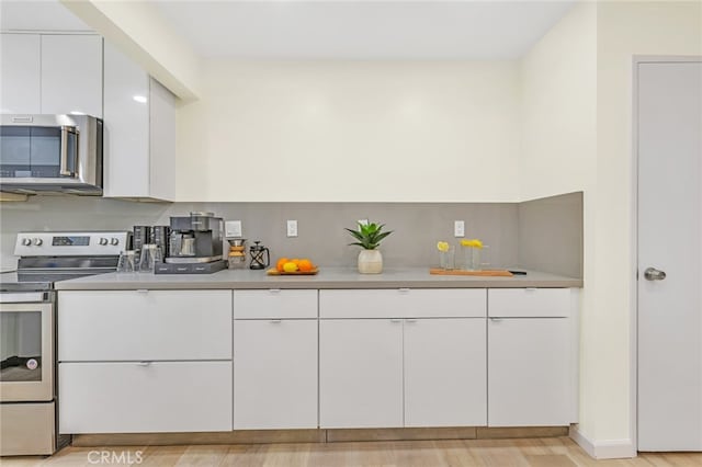 kitchen with white cabinetry, light countertops, and appliances with stainless steel finishes