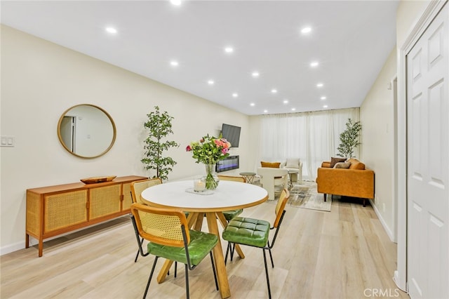 dining area with baseboards, recessed lighting, and light wood-type flooring