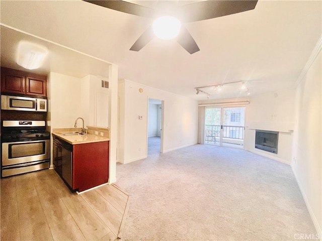 kitchen with light countertops, visible vents, ceiling fan, stainless steel appliances, and a sink