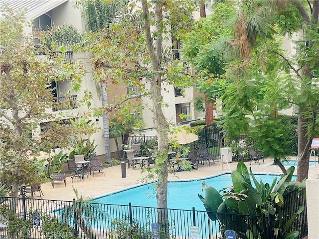pool featuring a patio and fence