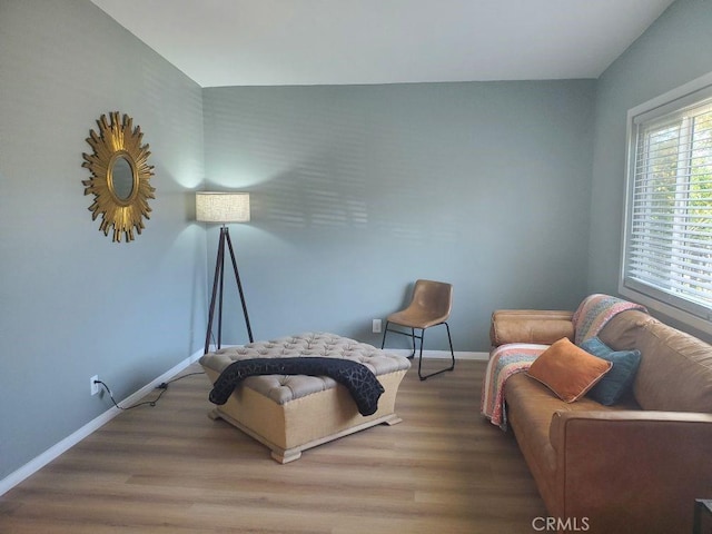 living area with wood finished floors and baseboards