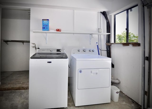 clothes washing area featuring laundry area and washing machine and dryer