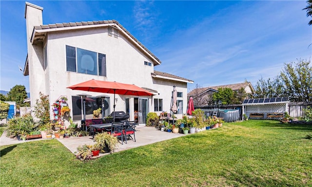 2773 W Summerset Dr, Rialto, CA 92377 - back of property with a patio, stucco siding, and a chimney