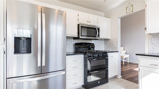 2773 W Summerset Dr, Rialto, CA 92377 - kitchen with appliances with stainless steel finishes, dark countertops, white cabinets, and decorative backsplash