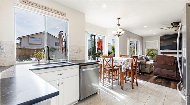 2773 W Summerset Dr, Rialto, CA 92377 - kitchen with appliances with stainless steel finishes, a sink, ceiling fan, white cabinets, and pendant lighting