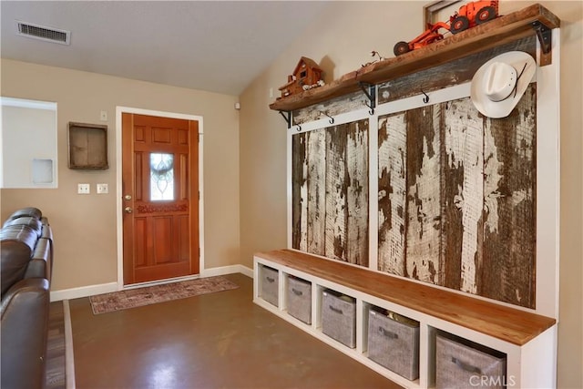 mudroom featuring finished concrete flooring, baseboards, and visible vents