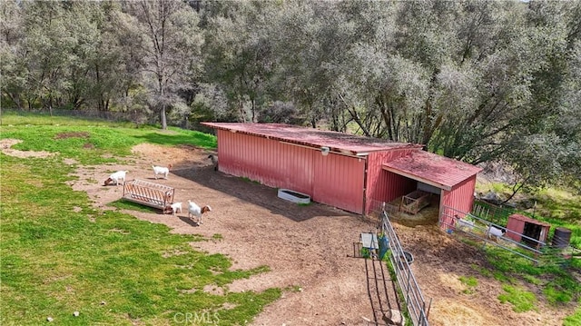 view of yard featuring an outdoor structure, an outbuilding, and an exterior structure