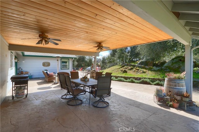 view of patio with a grill, ceiling fan, and outdoor dining space