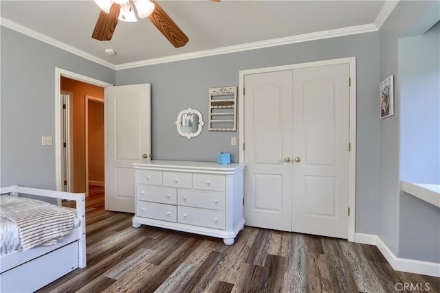 unfurnished bedroom featuring dark wood-style floors, a closet, and crown molding