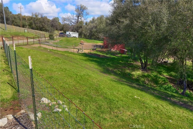view of yard featuring fence and a rural view