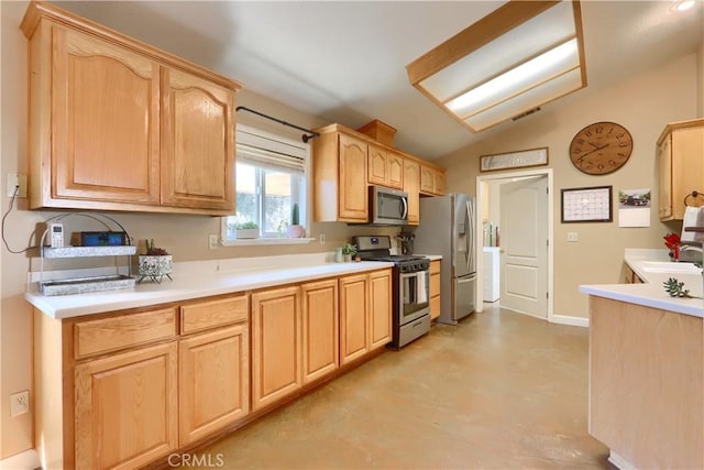 kitchen featuring vaulted ceiling, light countertops, light brown cabinetry, appliances with stainless steel finishes, and visible vents