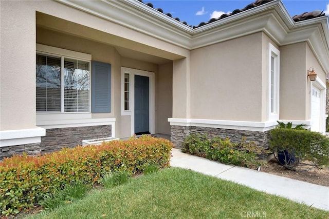 property entrance with stone siding and stucco siding
