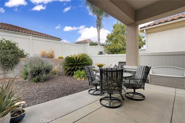 view of patio with a fenced backyard and outdoor dining area
