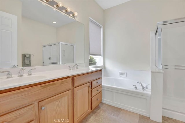 bathroom with a bath, double vanity, a sink, and a shower stall