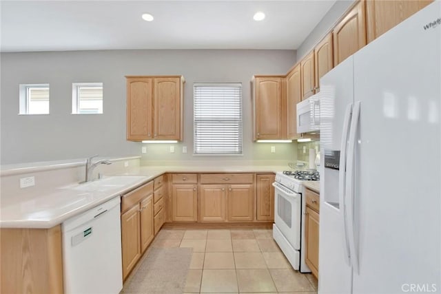 kitchen with light tile patterned flooring, a wealth of natural light, a sink, light brown cabinets, and white appliances
