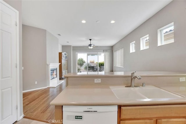 kitchen with dishwasher, ceiling fan, recessed lighting, a sink, and light wood-type flooring